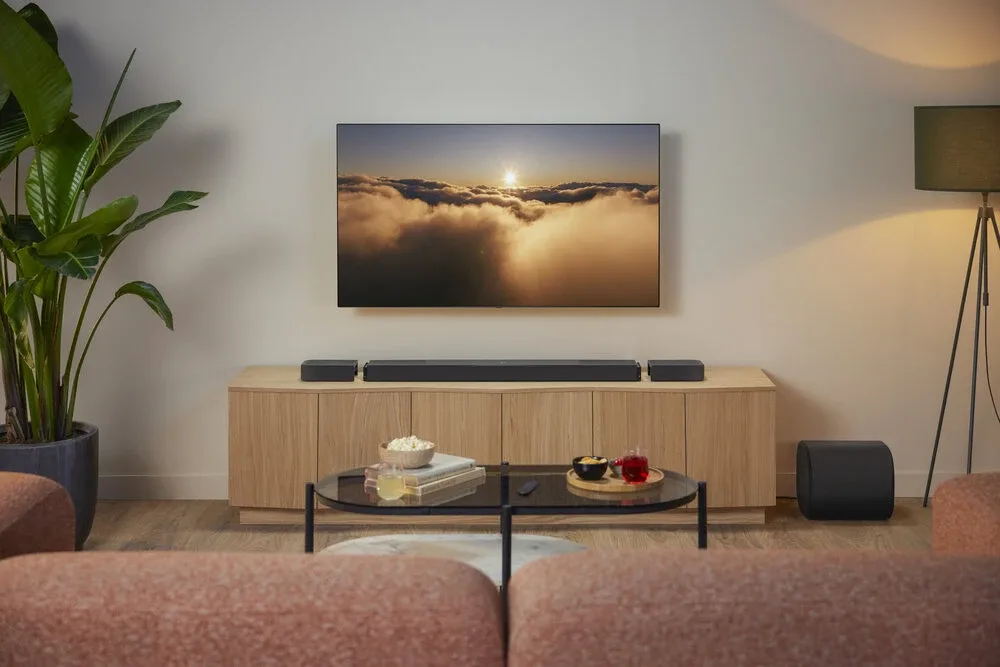 Loa soundbar JBL Bar 1300MK2 gắn dưới TV trong phòng khách, kèm loa siêu trầm
